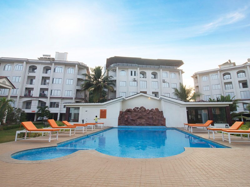 The pool deck with loungers, the suite blocks behind